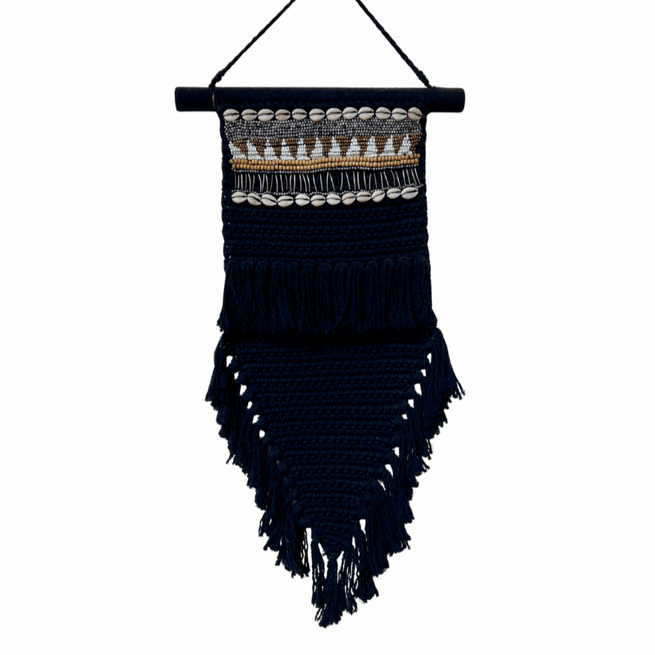 Black woven wall hanging with fringe on a white background