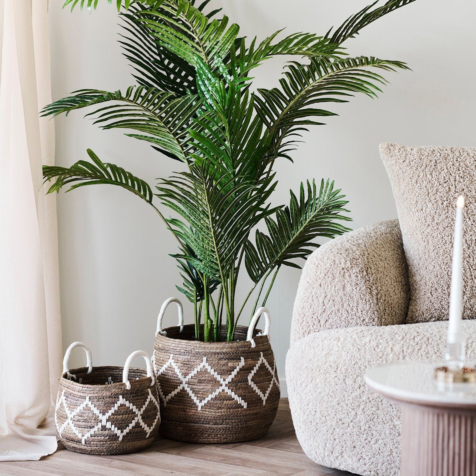 Kayu Living set of two handcrafted banana-leaf baskets in natural and ivory with organic woven patterns and white handles