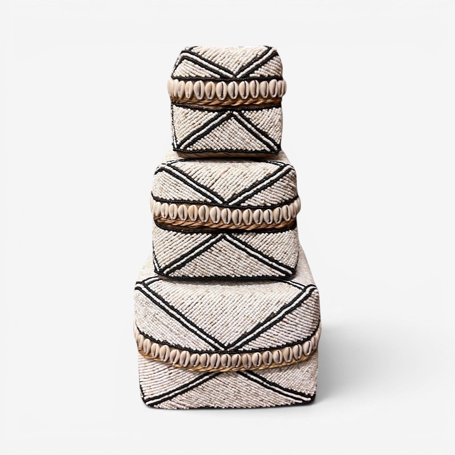 Kayu Living handmade beaded boxes in black, white, and natural shells. Decorative storage boxes with geometric patterns.