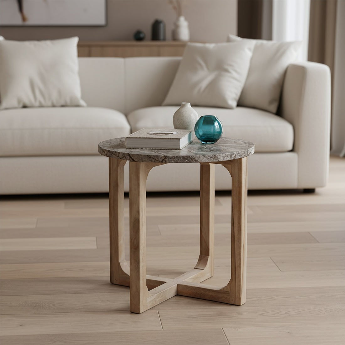 Kayu Living Bizar side table with a round marble top featuring rust-brown and green veins on a crossed mango wood base.