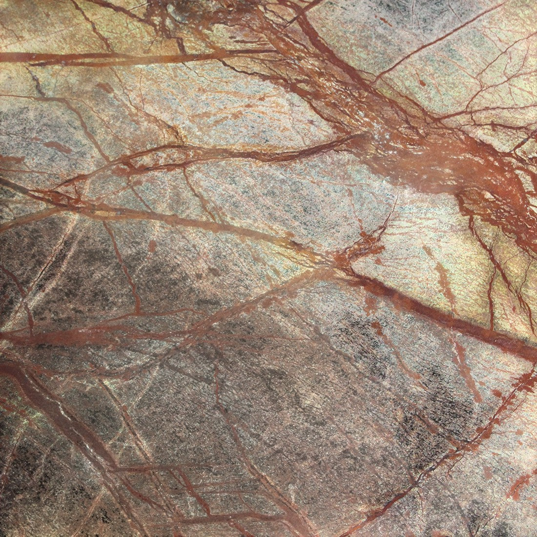 Close-up of the Kayu Living Bizar marble coffee table top featuring intricate red and green veining on stone.