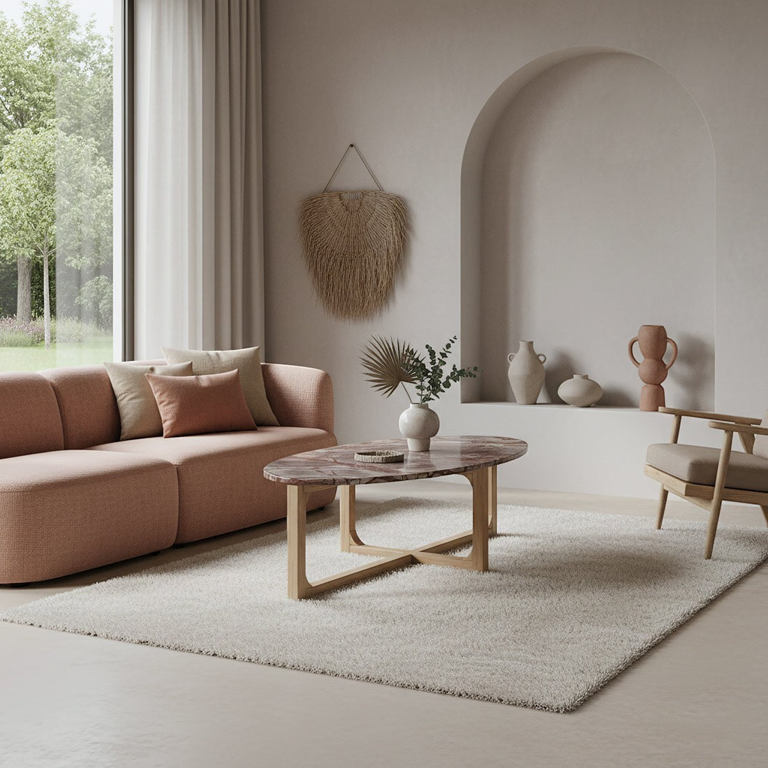 Kayu Living Bizar oval marble coffee table with a veined top and light mango wood cross-frame in a modern living room