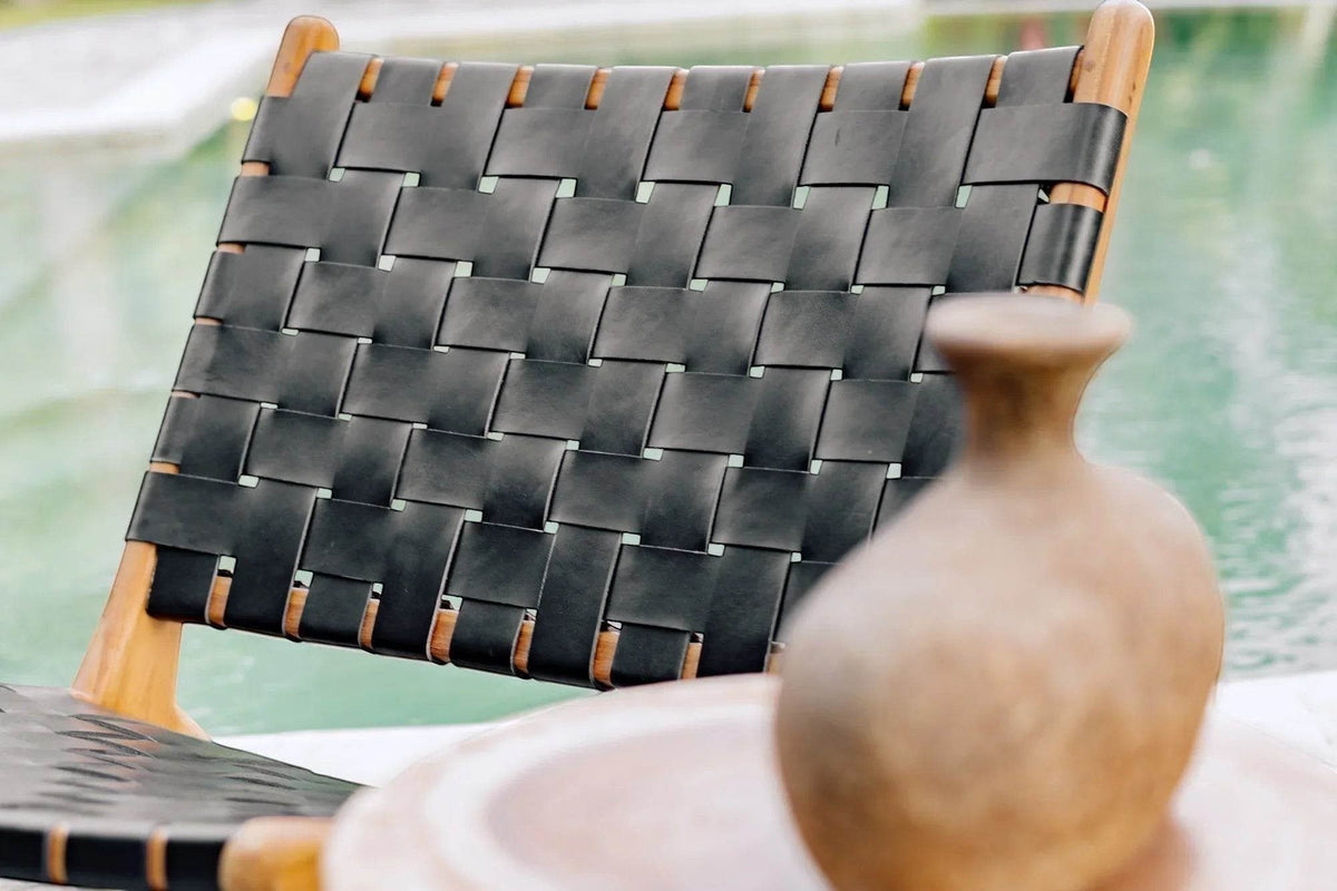 Kayu Living black handwoven leather lounge chair with teak frame, perfect for modern living spaces.