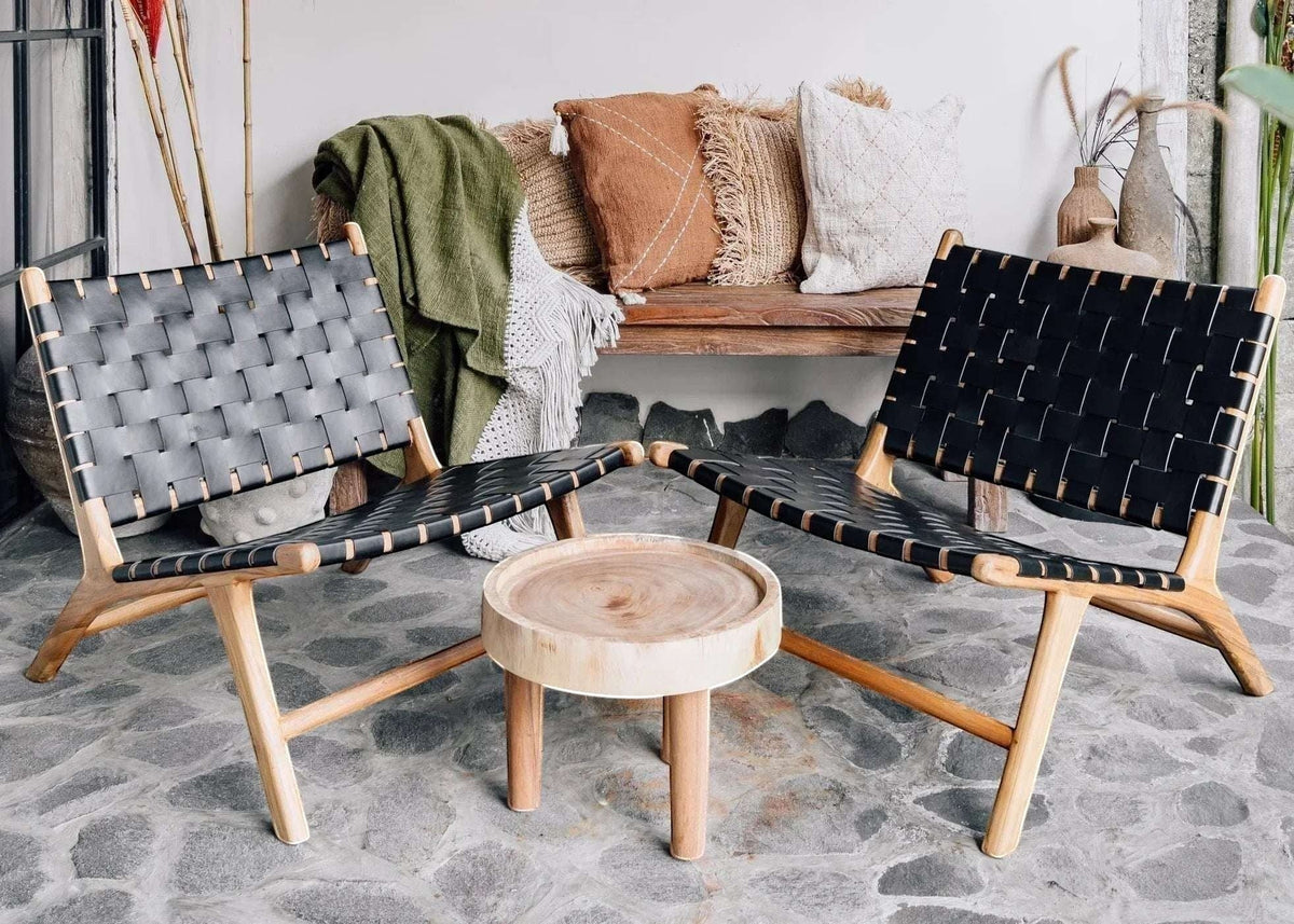 Kayu Living Umalas lounge chair with black handwoven leather seat and natural teak frame. Modern, minimalist design.