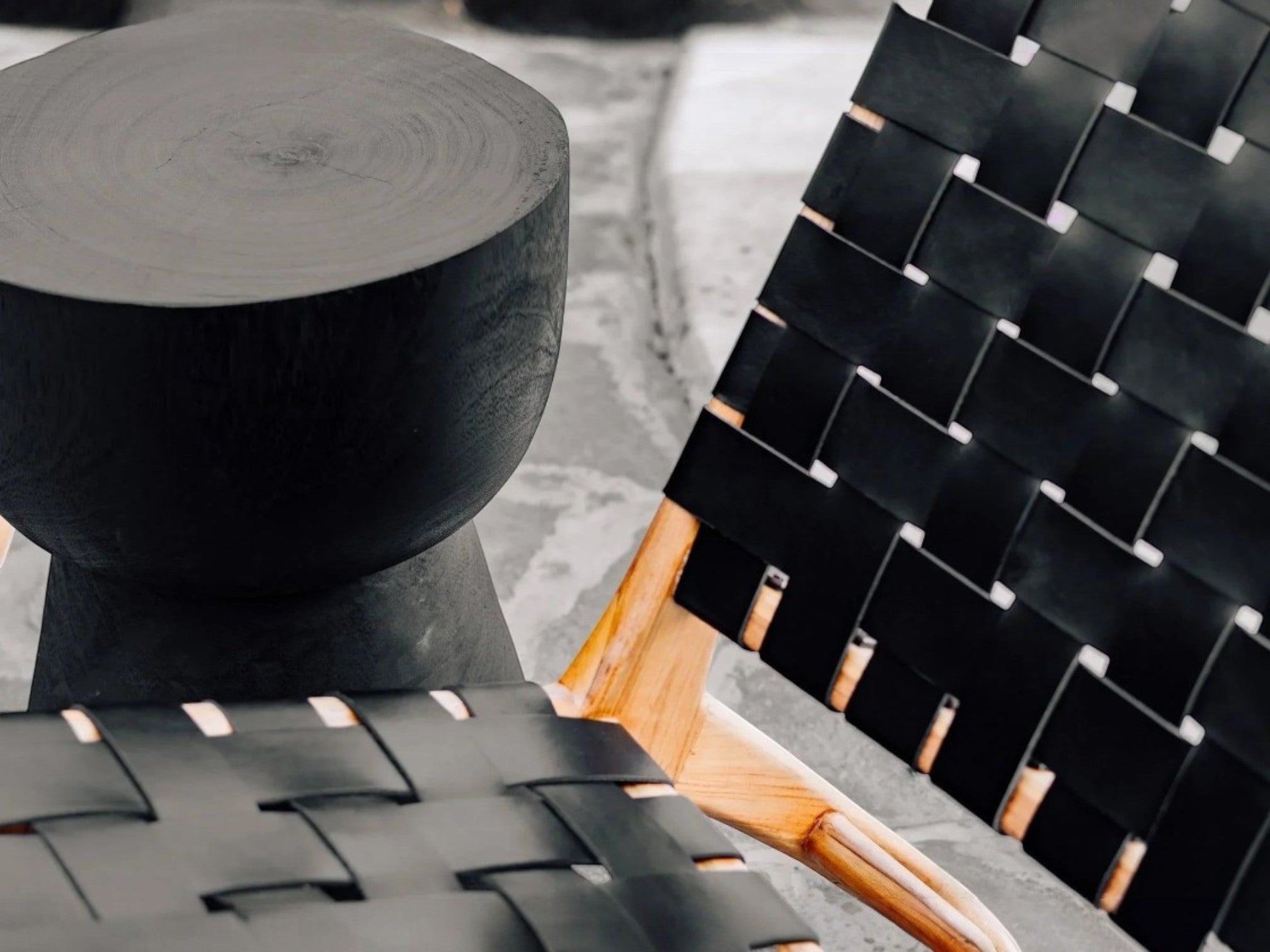 Kayu Living black cupped suar wood stool with natural grain and rustic cracks, unique handcrafted design.