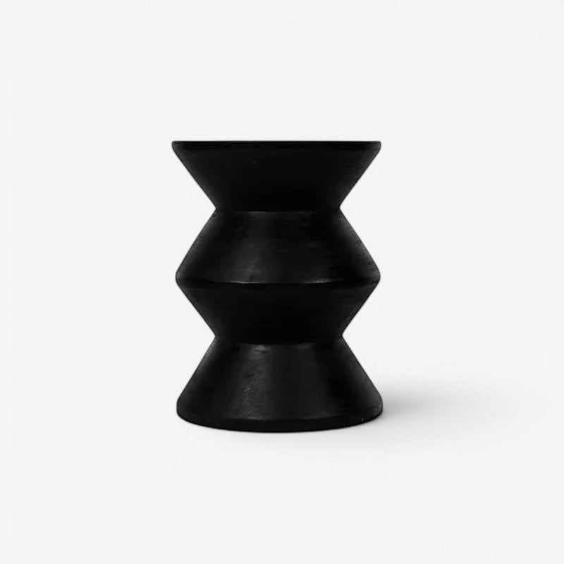 Kayu Living black solid suar wood zigzag stool with hourglass shape and rustic charm.