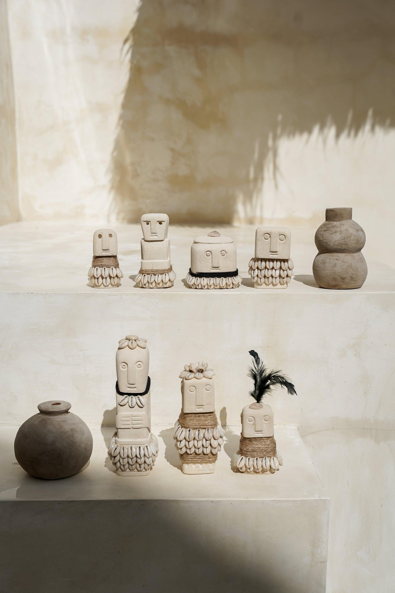Kayu Living handmade Boho Stone Men figurines with natural stone, jute, and shell accents on a tiered display