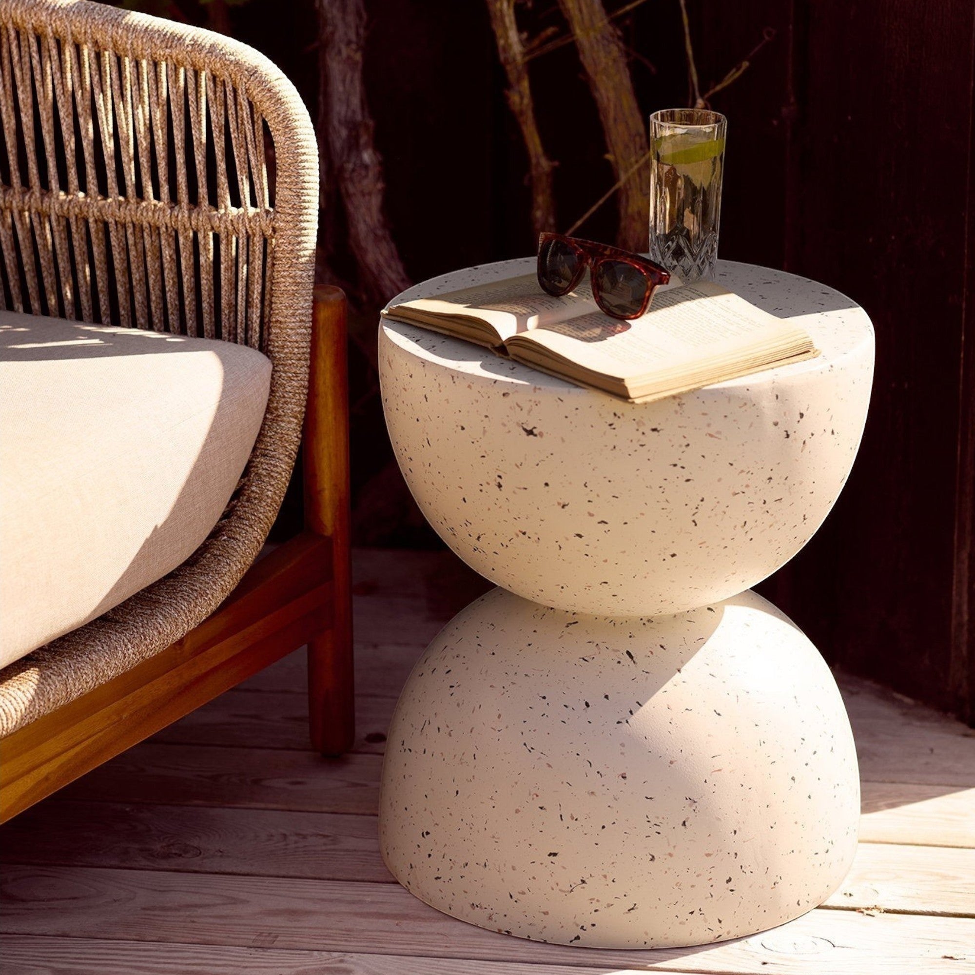 Kayu Living Bonita off-white fiberclay side table with a terrazzo finish, styled on a wooden patio deck.
