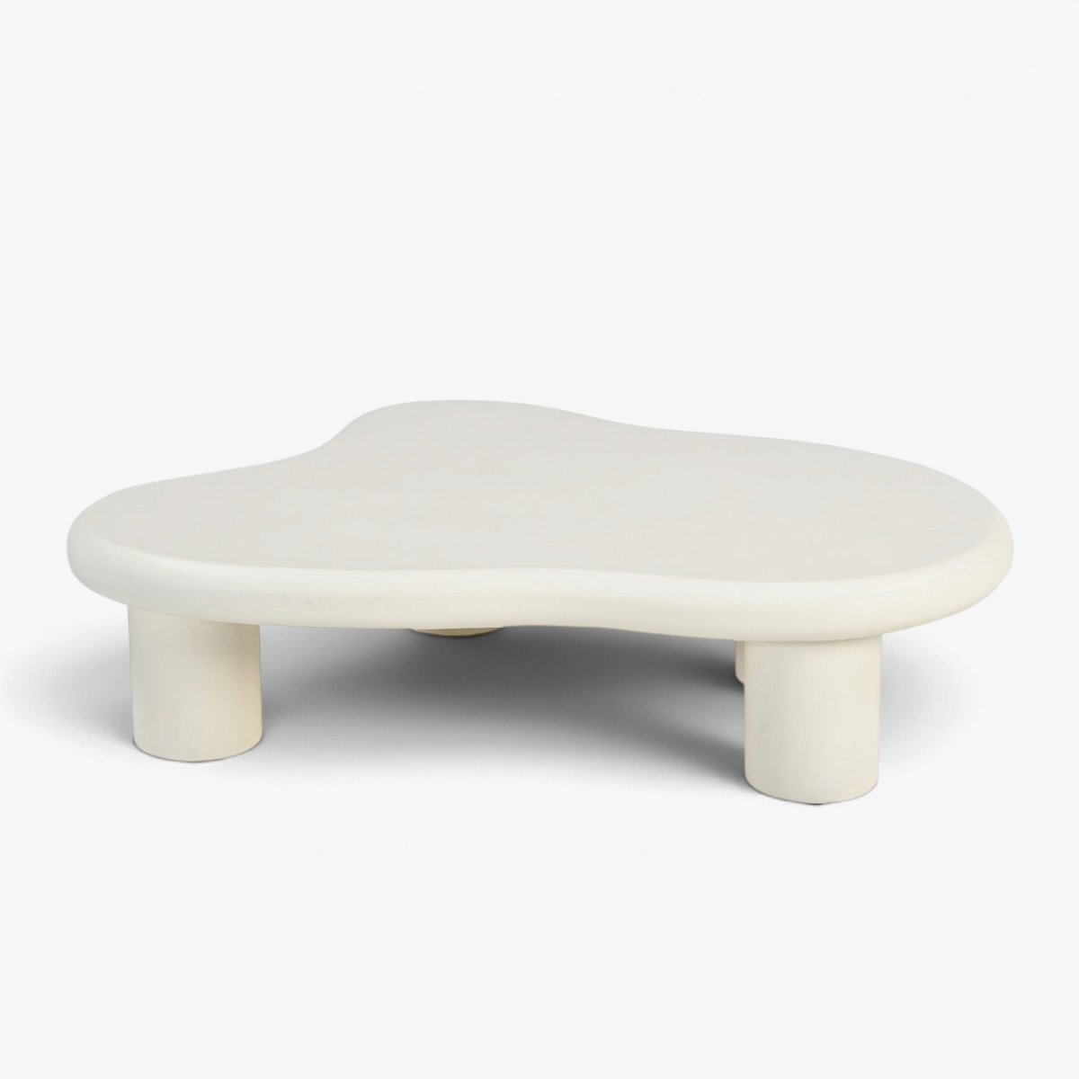 Kayu Living Brix Feline Sandy coffee table with an organic, beige concrete-ciré top and sturdy cylindrical legs.