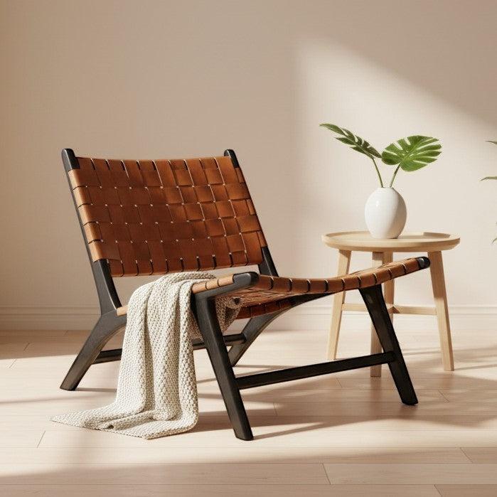 Kayu Living Philippa lounge chair with handwoven brown leather seat and black teak frame. Comfortable, textured, and stylish.