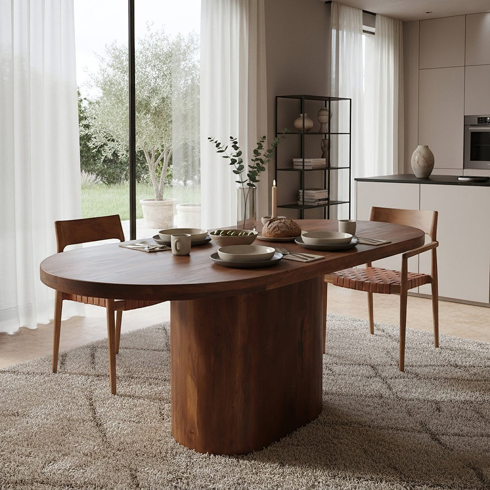 Kayu Living bullnose oblong dining table in solid mango wood with a sturdy central pedestal leg in a modern dining room.