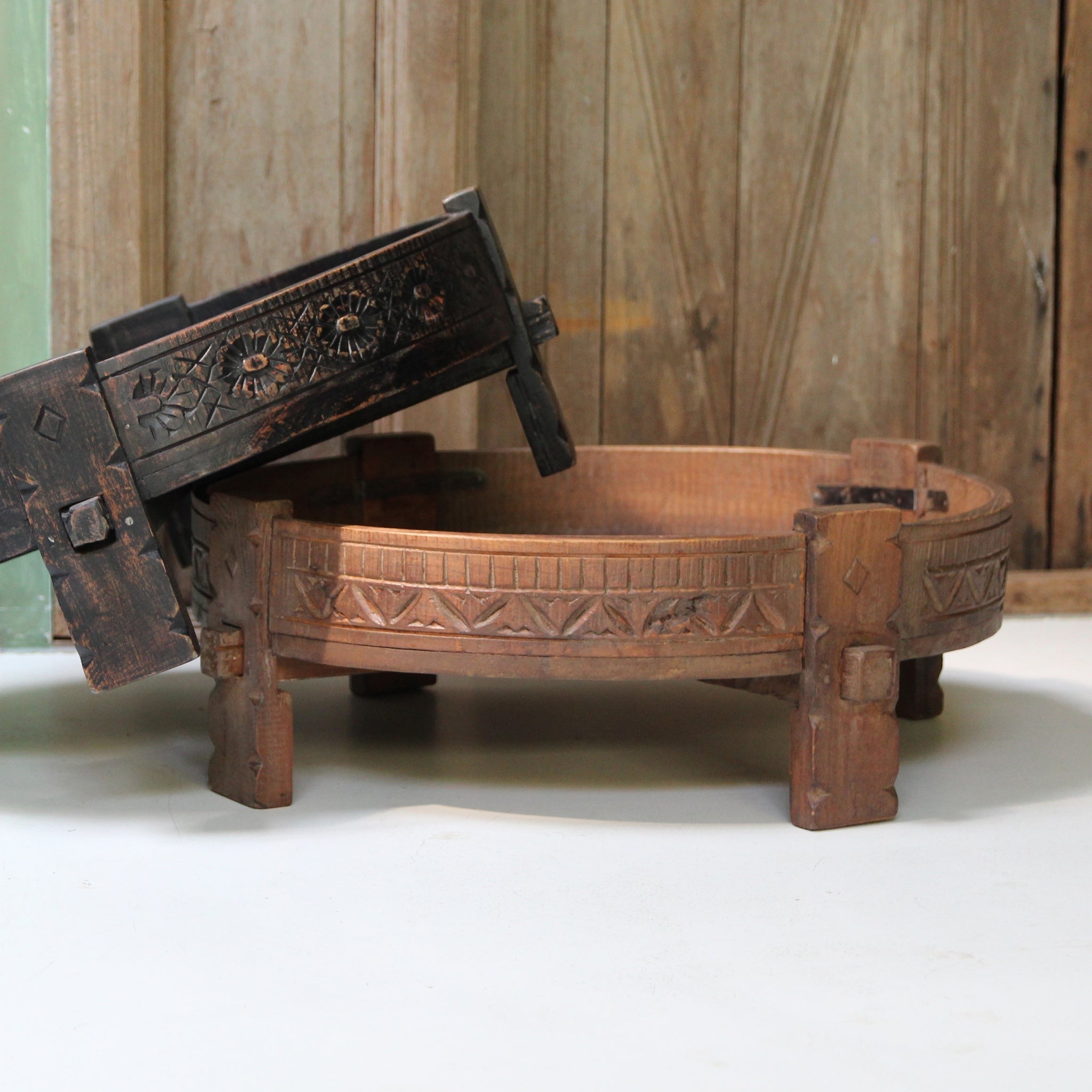 Kayu Living handcrafted round Chakki side table made from recycled hardwood with intricate carved details and patina.