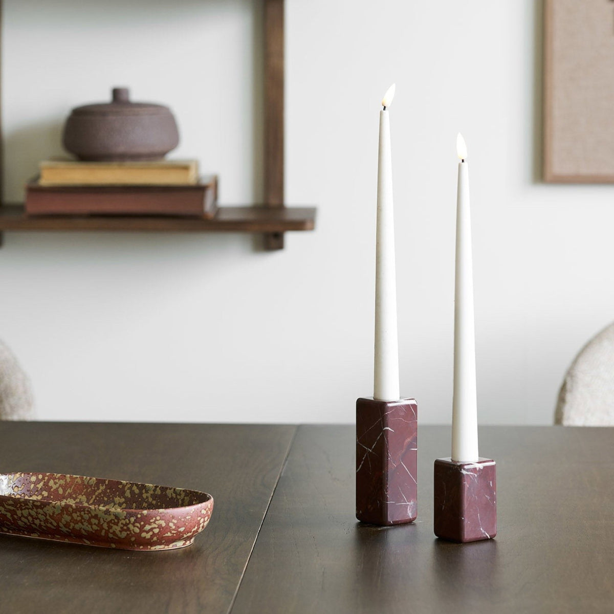 Kayu Living set of two chestnut-red solid marble candle holders with minimalist design on a dark wooden table