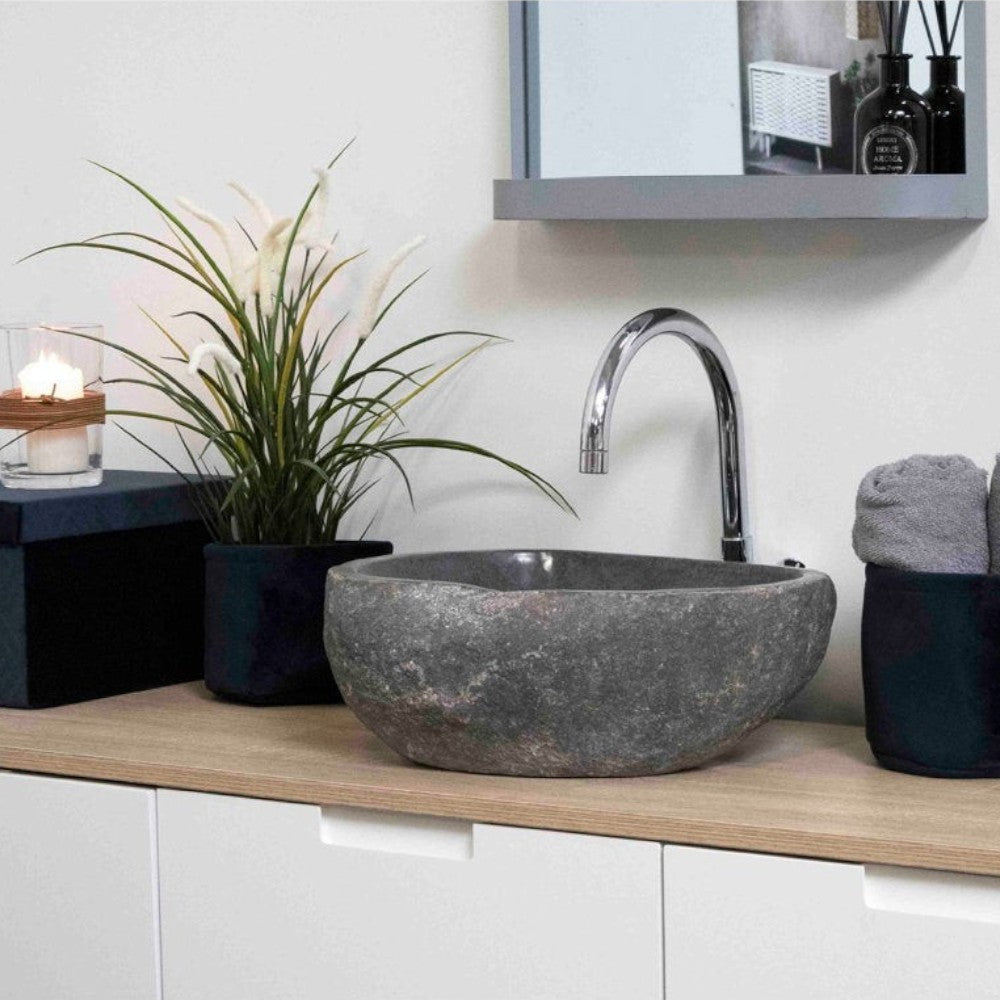 Kayu Living Donau riverstone sink with natural grey stone texture on a wooden vanity in a modern bathroom setting