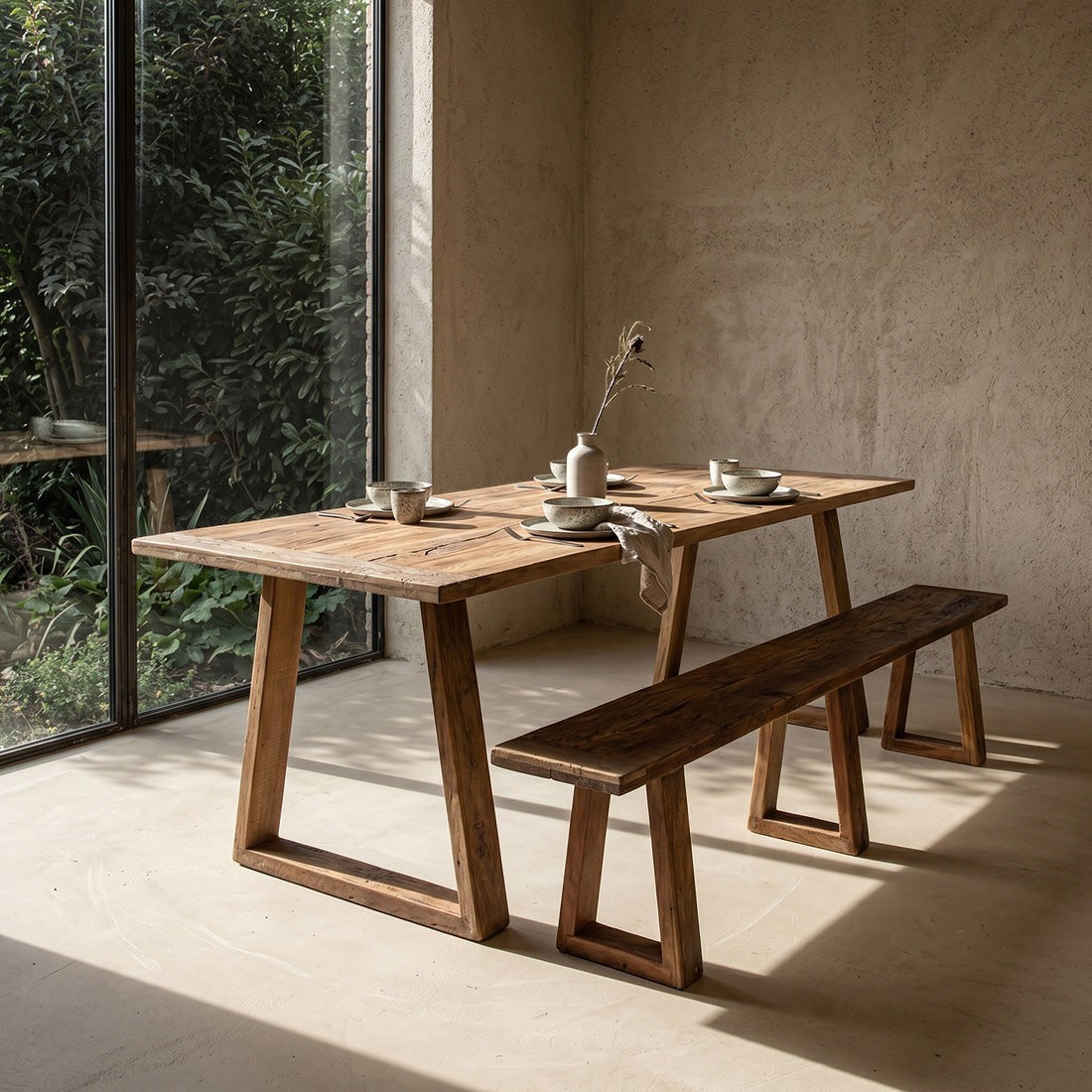 Kayu Living Farmwood dining table and matching bench made from recycled brown wood with natural grain and knots.