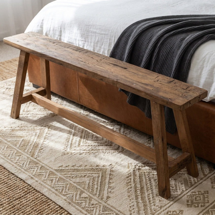 Kayu Living Farmwood 115cm bench made from reclaimed FSC-certified wood with natural rustic texture at a bed foot.