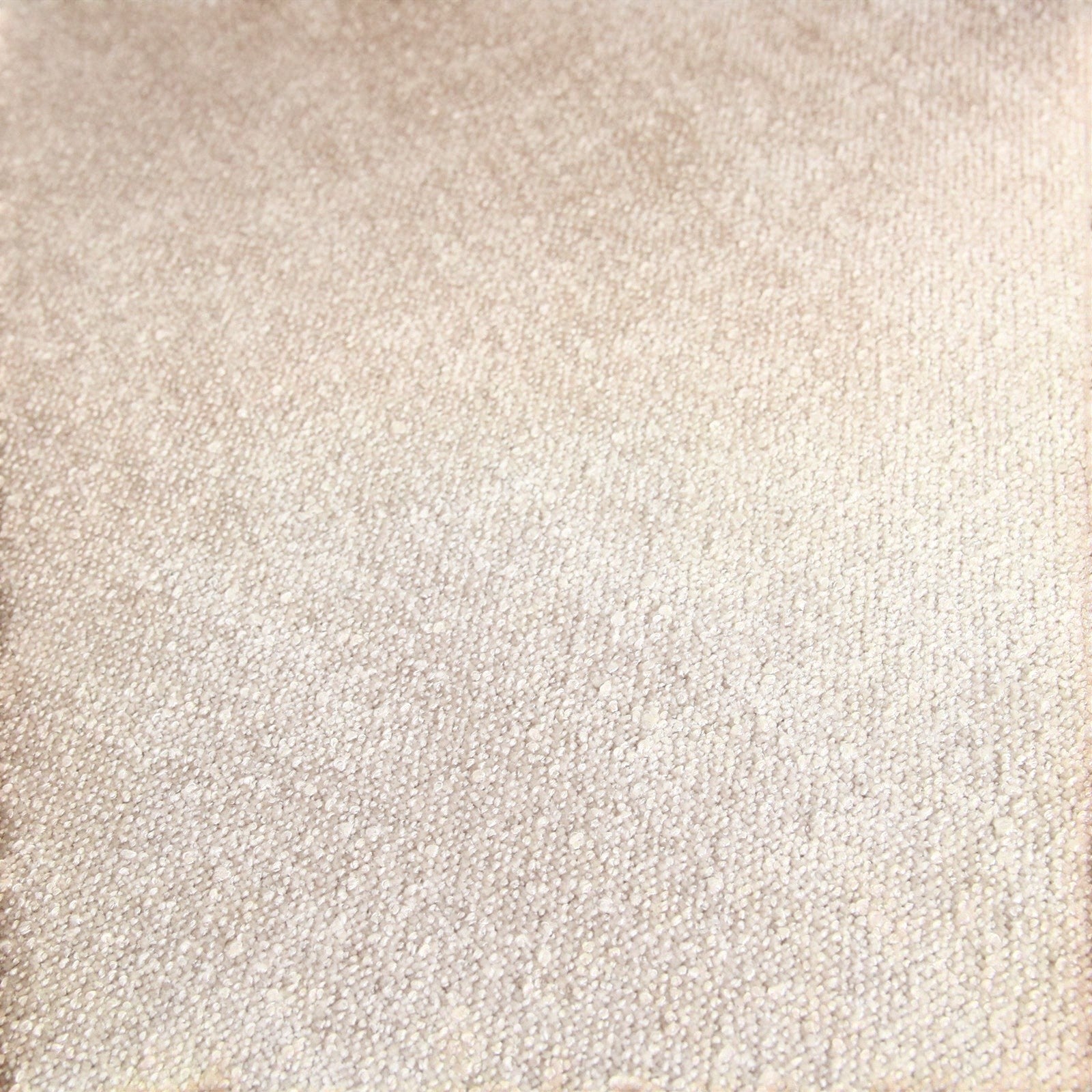 Close-up of the cream-colored textured fabric upholstery on a Kayu Living Freya teak dining chair.