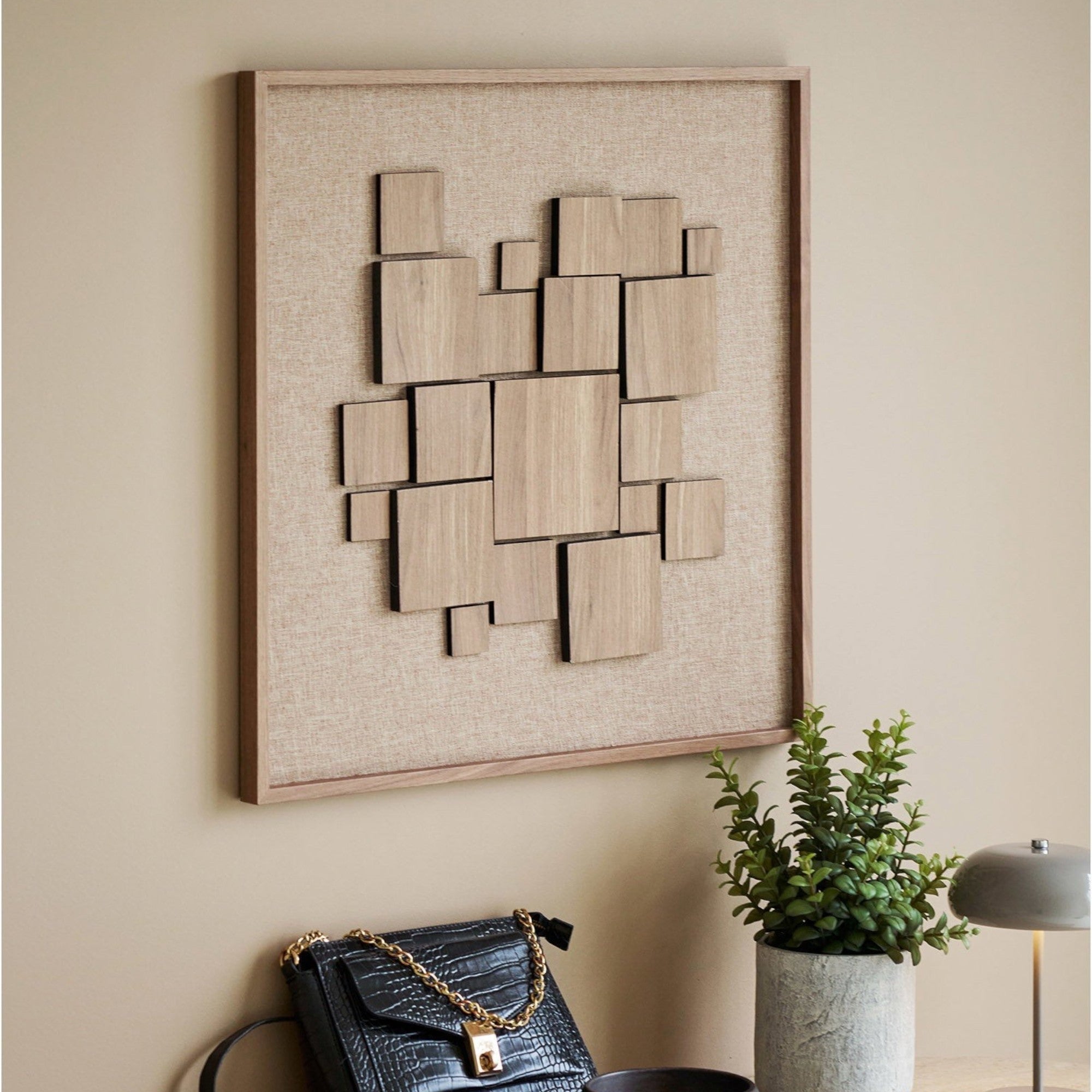 Kayu Living Gala relief wall art featuring brown geometric wooden squares on a textured fabric background.