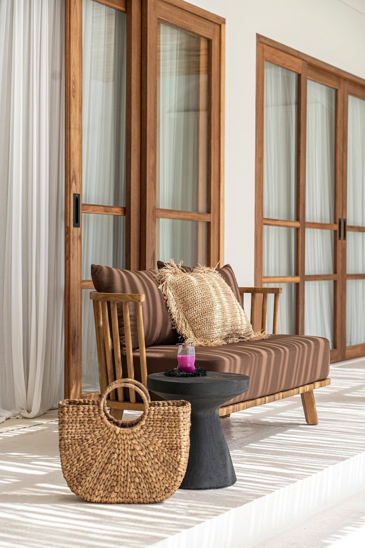 Kayu Living Gravity Side Table in black suar wood, a modern pedestal design with a smooth finish.