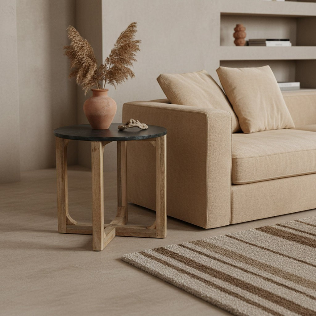 Kayu Living round side table with a deep green marble top and natural mango wood base in a minimalist living room.