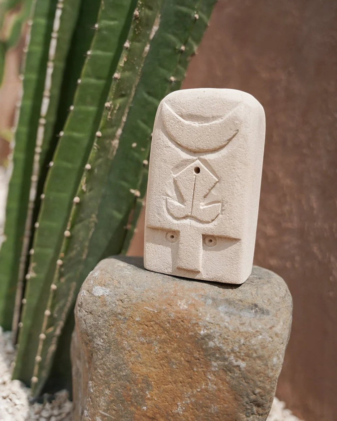 Kayu Living handmade stone guardian figurine with carved mystical symbols, natural beige finish, 14cm tall.