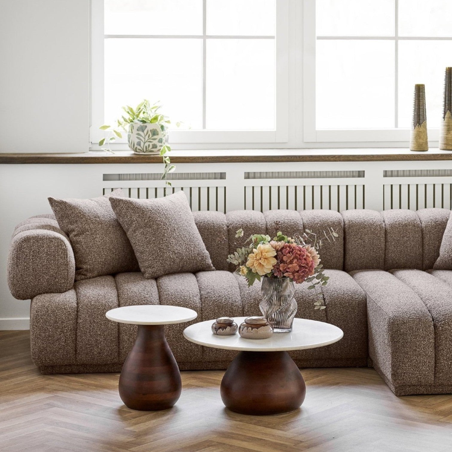 Kayu Living Heide round coffee tables featuring dark brown mango wood bases and white marble tops in a living room.