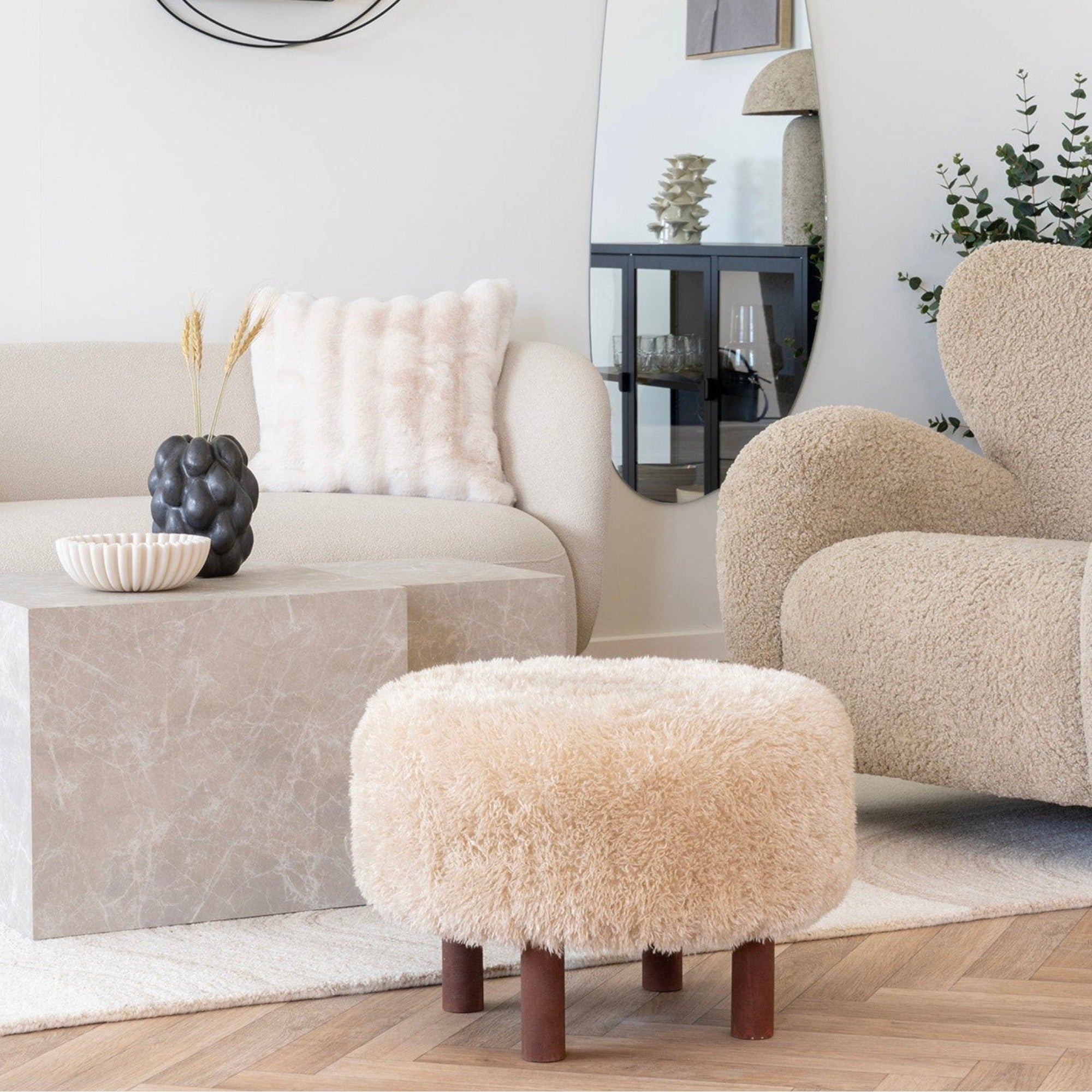 Kayu Living Inverness Pouf, round cream boucle ottoman with dark wood legs, perfect as footrest or extra seating.
