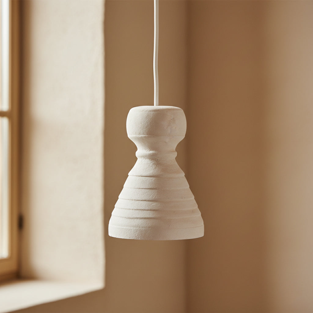Kayu Living Kanoi pendant lamp in off-white Ecomix with a matte, chalky texture and organic, carved stone aesthetic.