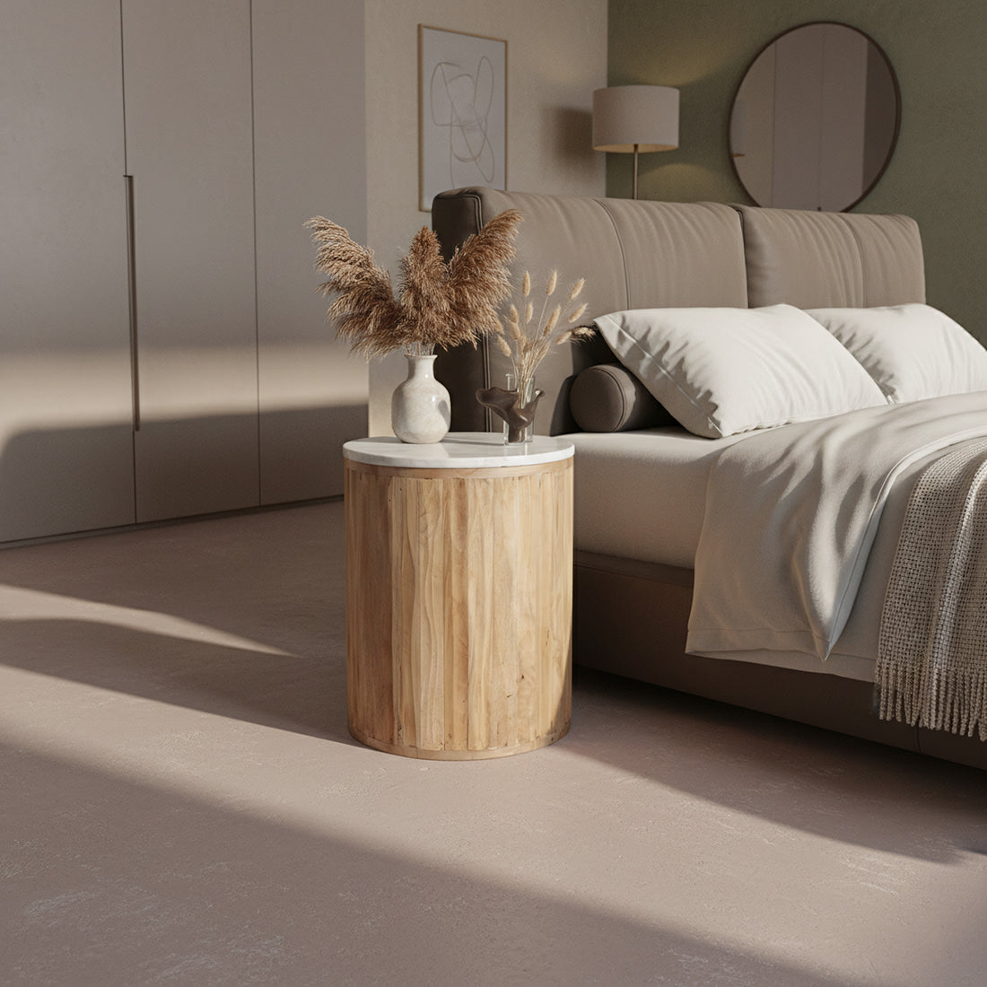 Kayu Living Malakka white marble side table with a carved cylindrical mango wood base in a modern bedroom setting.