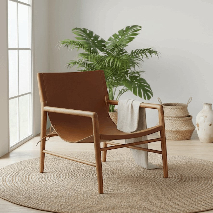 Kayu Living Marita lounge chair in cognac leather and teak wood frame. Modern armchair with a minimalist design.