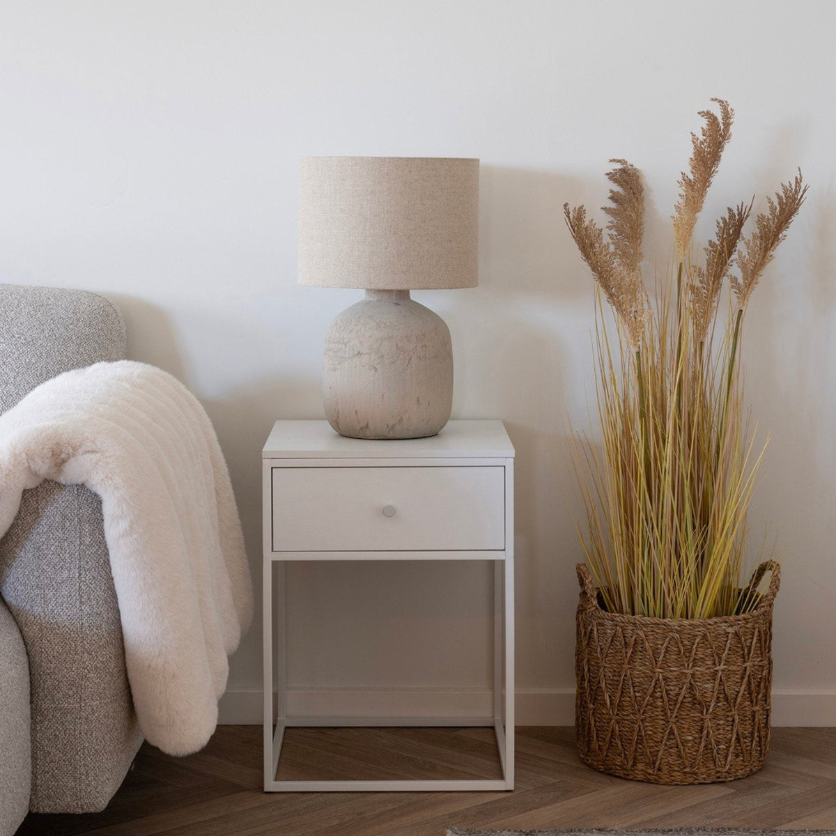 Kayu Living set of 3 handcrafted natural seagrass baskets used as a decorative planter for tall dried grass
