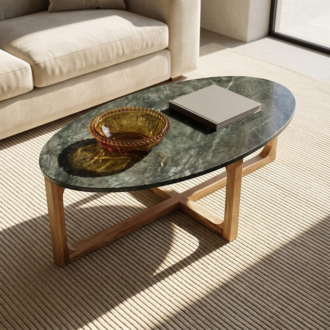 Kayu Living oval coffee table with a green marble top and sustainable mango wood base in a bright living room.