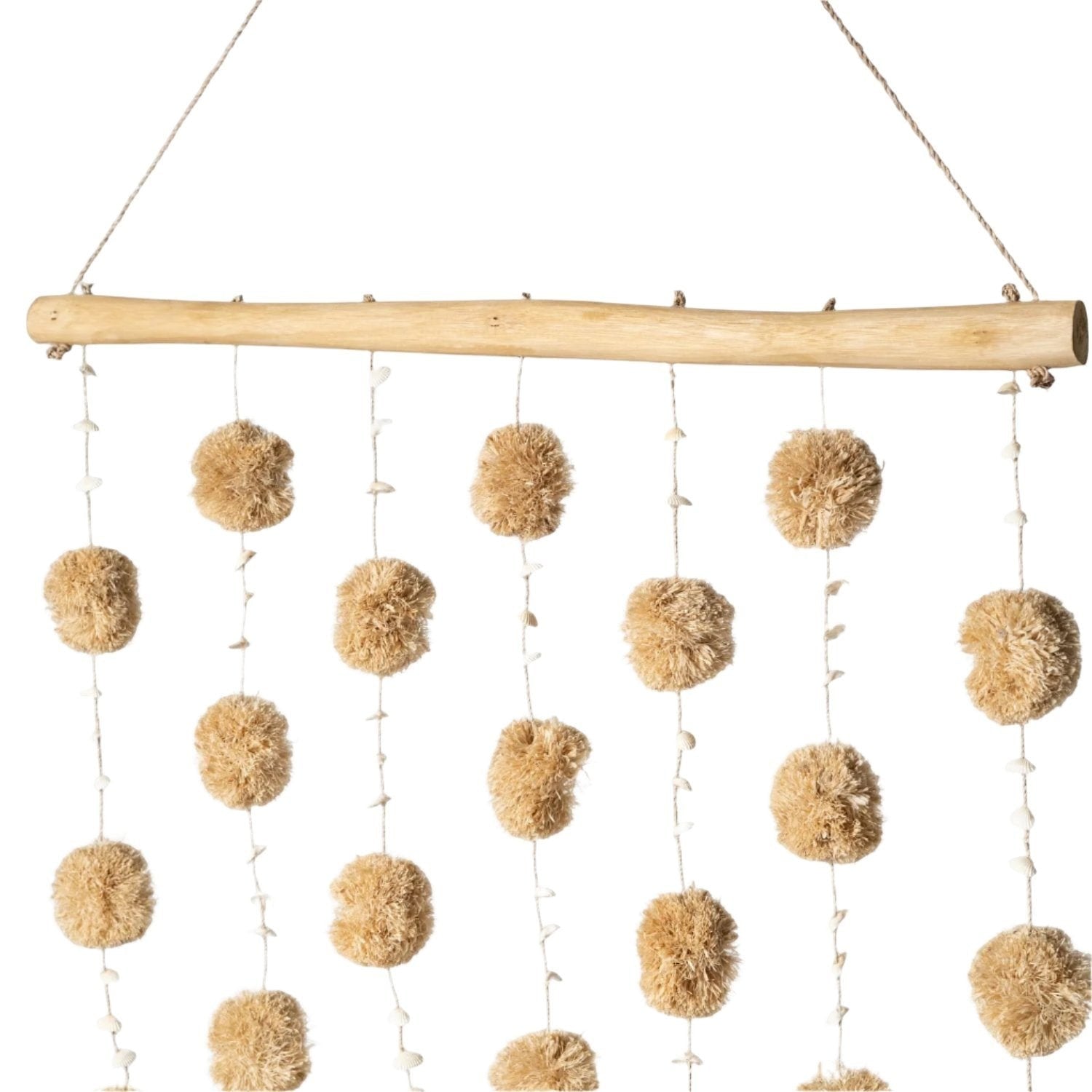 Kayu Living natural tan pom pom wall hanging with small shells on driftwood.