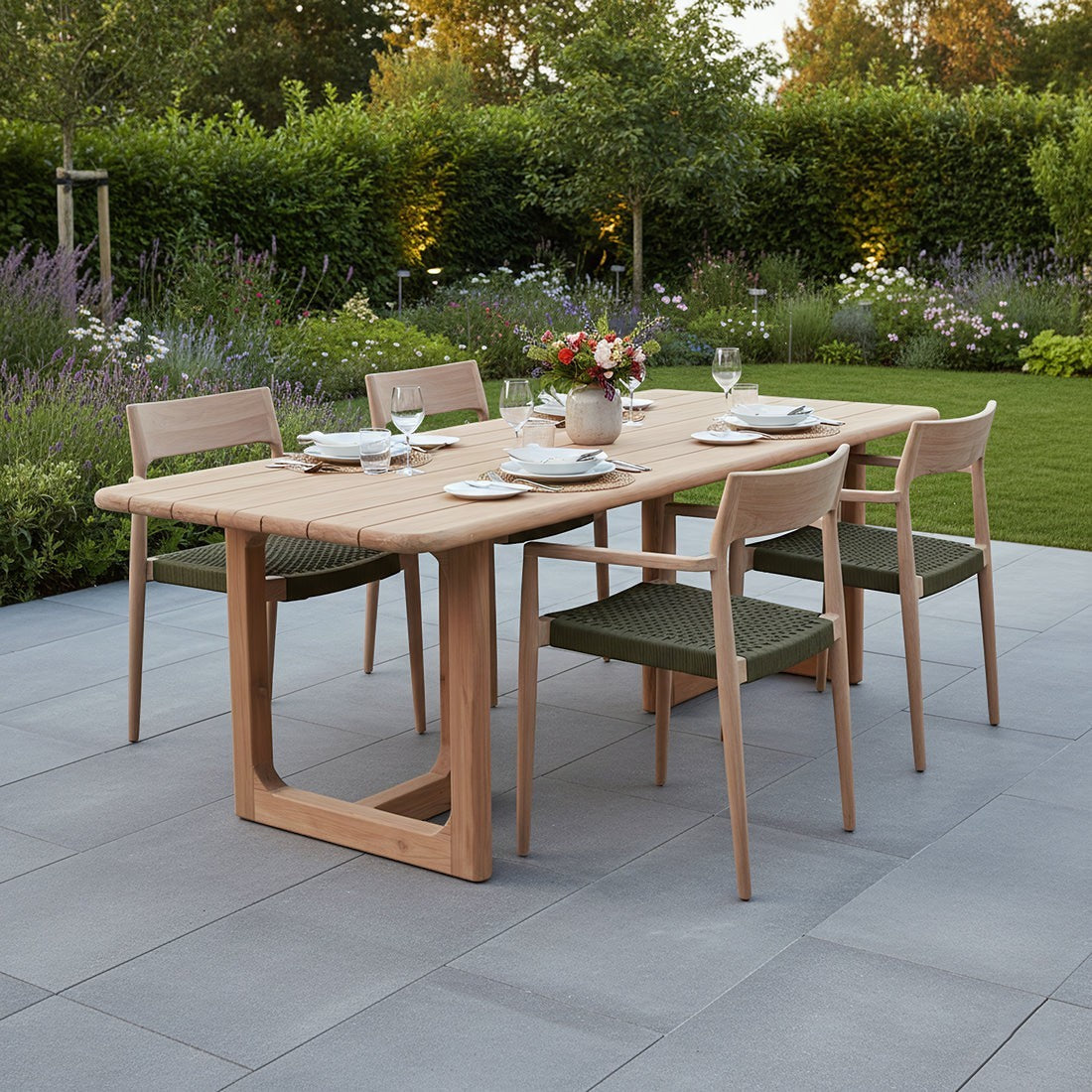 Kayu Living Primavera 240 cm recycled teak garden table with U-shaped legs and matching chairs on a patio.