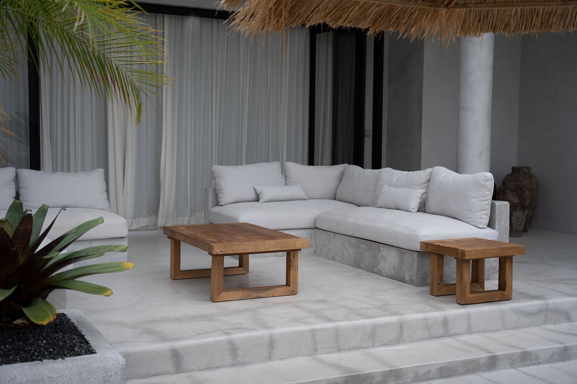 Kayu Living reclaimed teak coffee table with natural wood finish in a modern outdoor patio setting