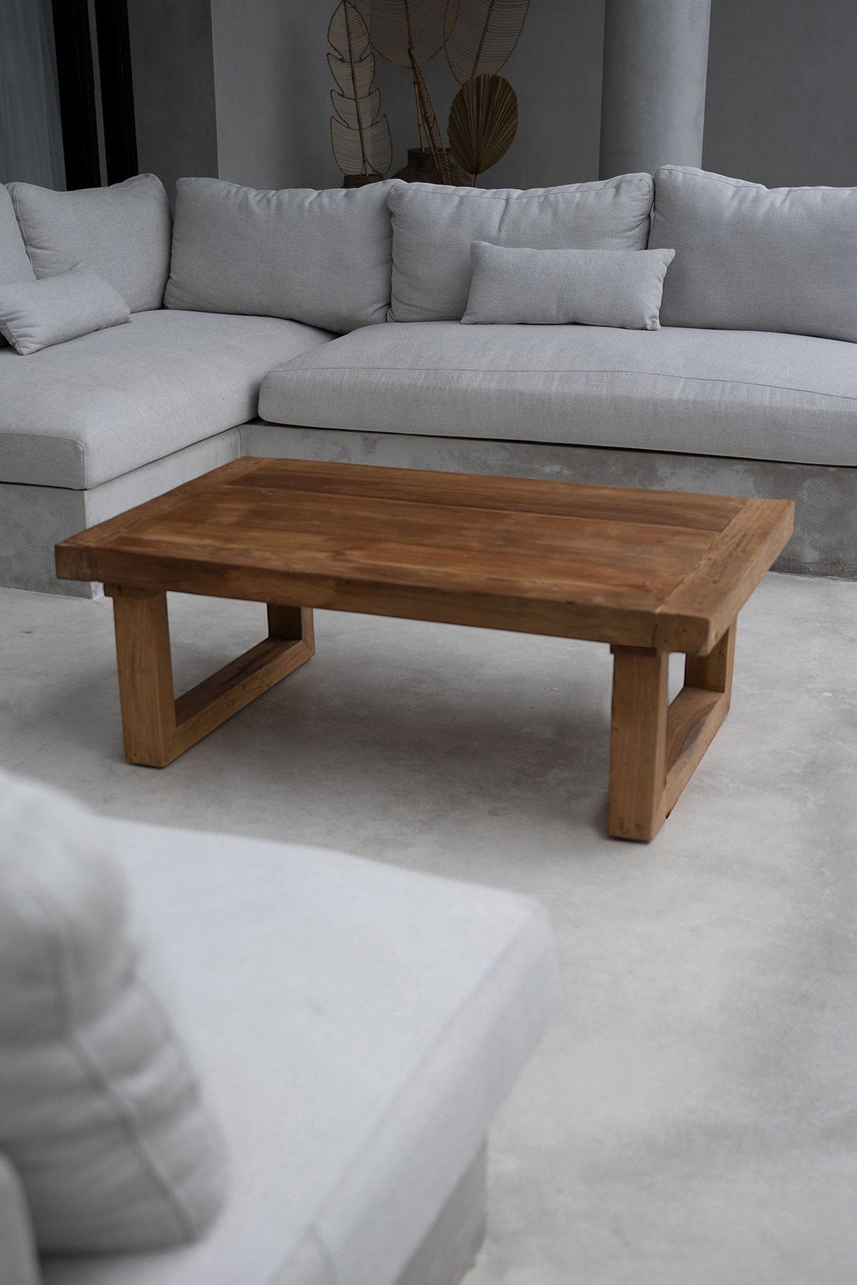 Kayu Living reclaimed teak coffee table with a natural wood finish in a modern living room setting.