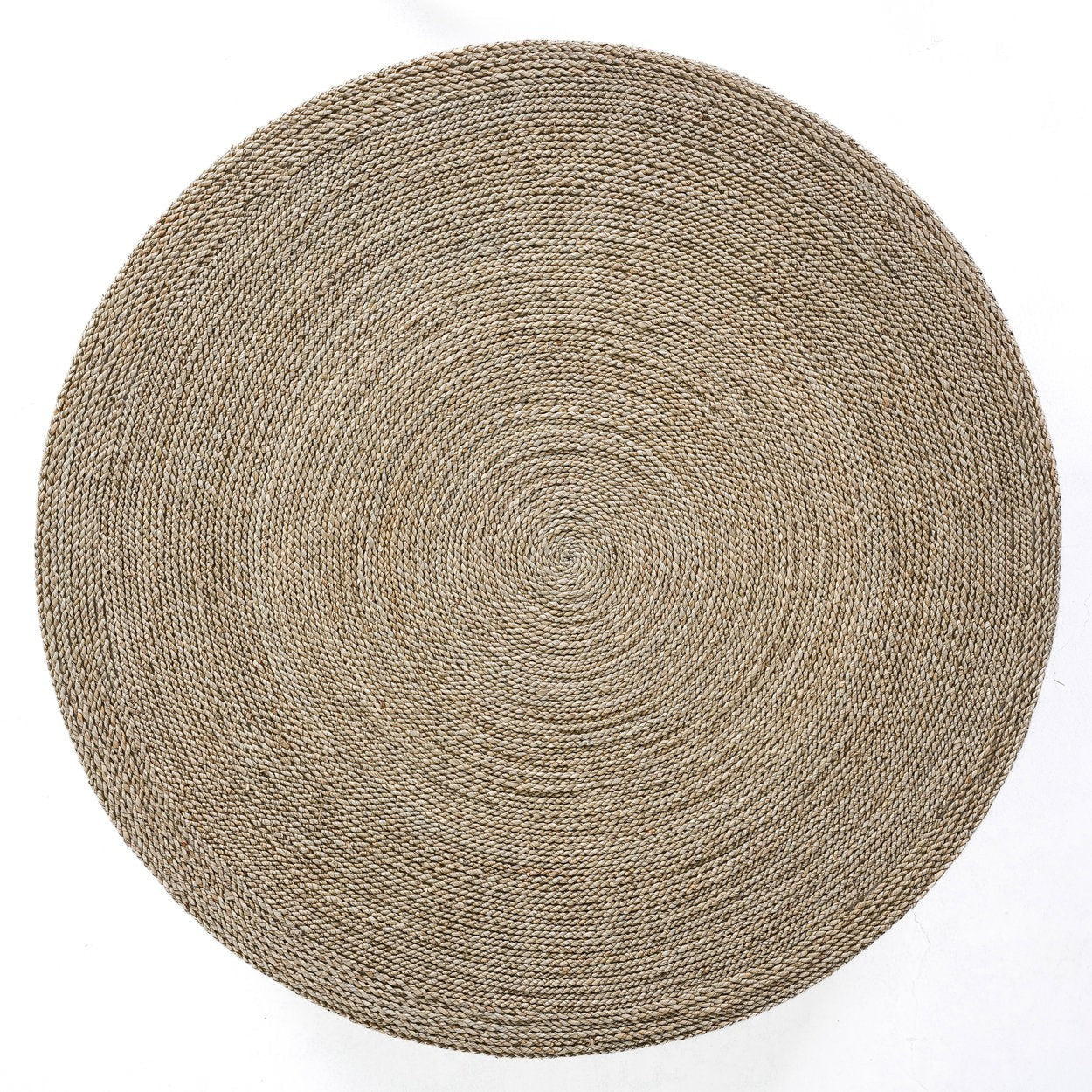 Kayu Living handcrafted round seagrass pouf with a natural woven texture and spiral pattern, top-down view.