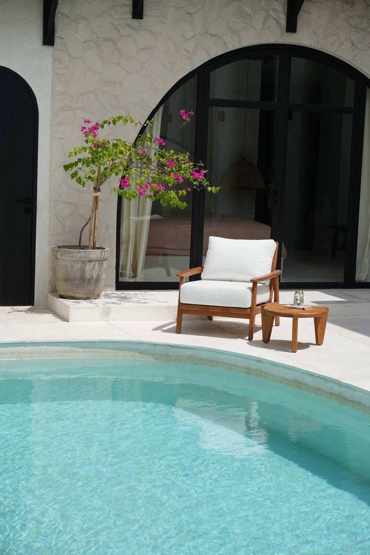 Kayu Living Seseh outdoor coffee table in reclaimed teak with sculptural three-leg design.