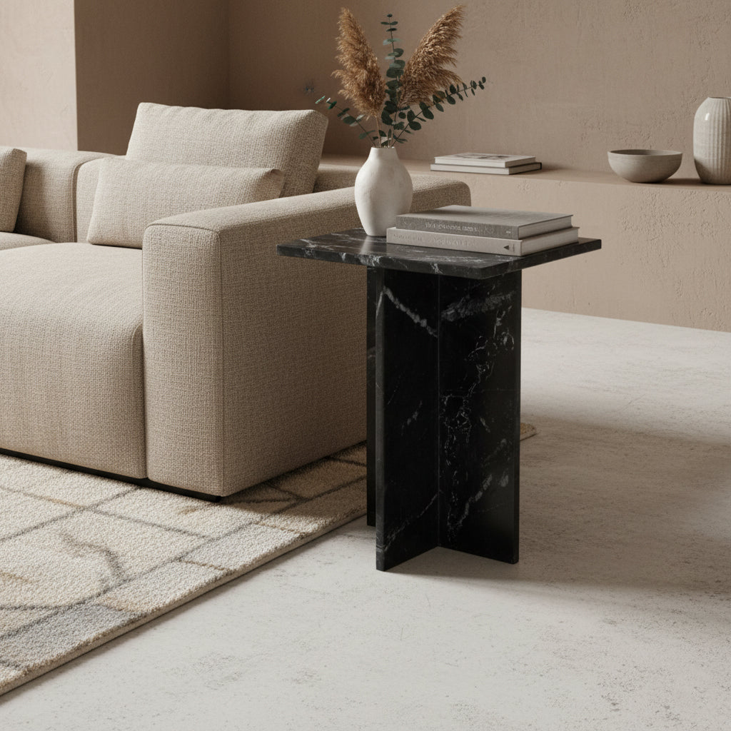 Kayu Living Shanghai black marble side table with white veining and a crossed base in a modern living room setting.