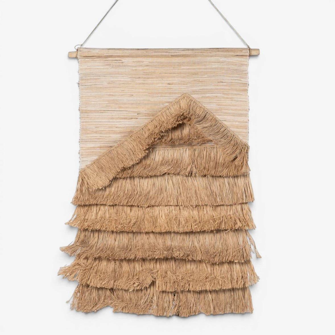 Kayu Living natural sisal wall hanging with layered fringe detail and triangular accent.