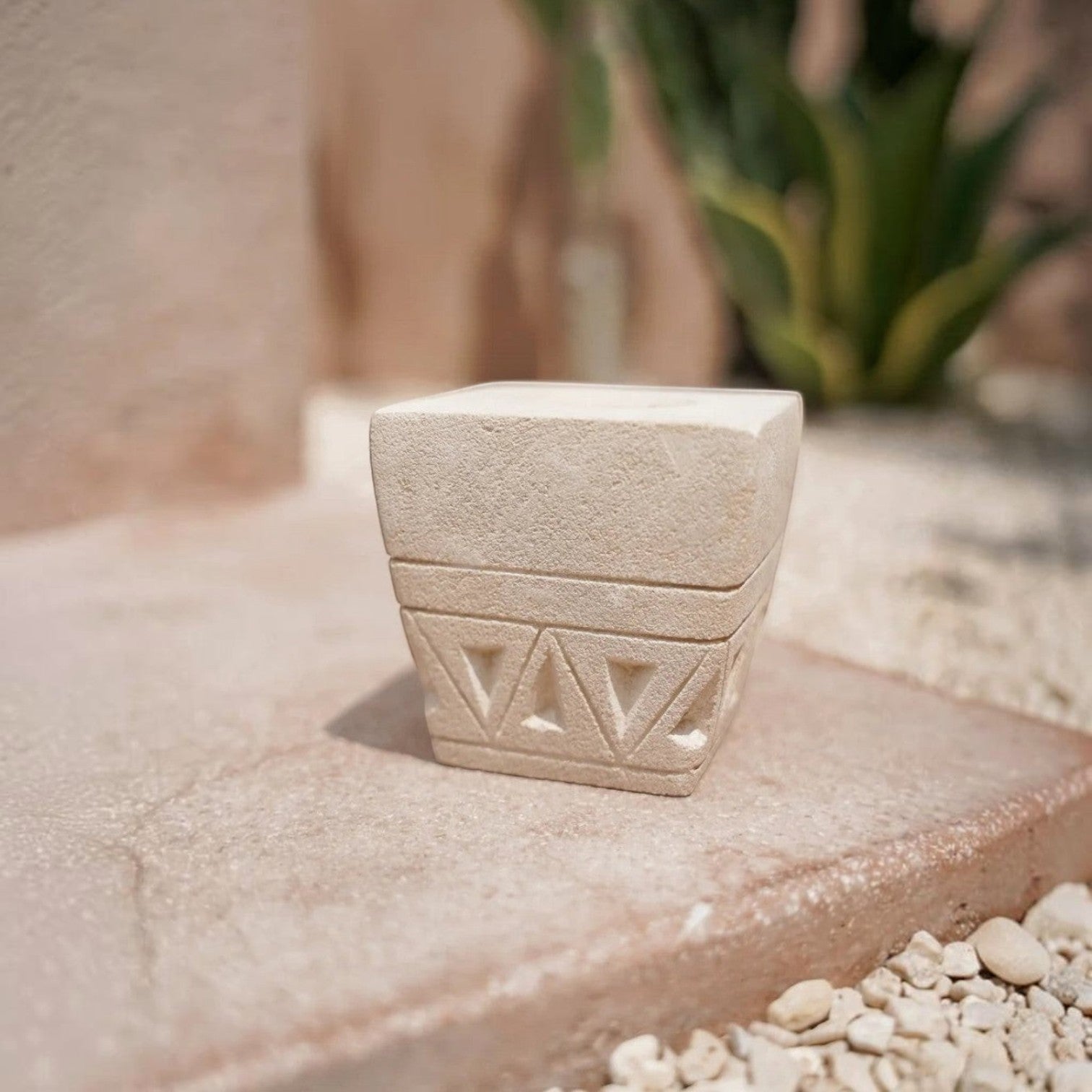 Kayu Living handmade stone candle holder with intricate geometric engravings and a natural textured finish.