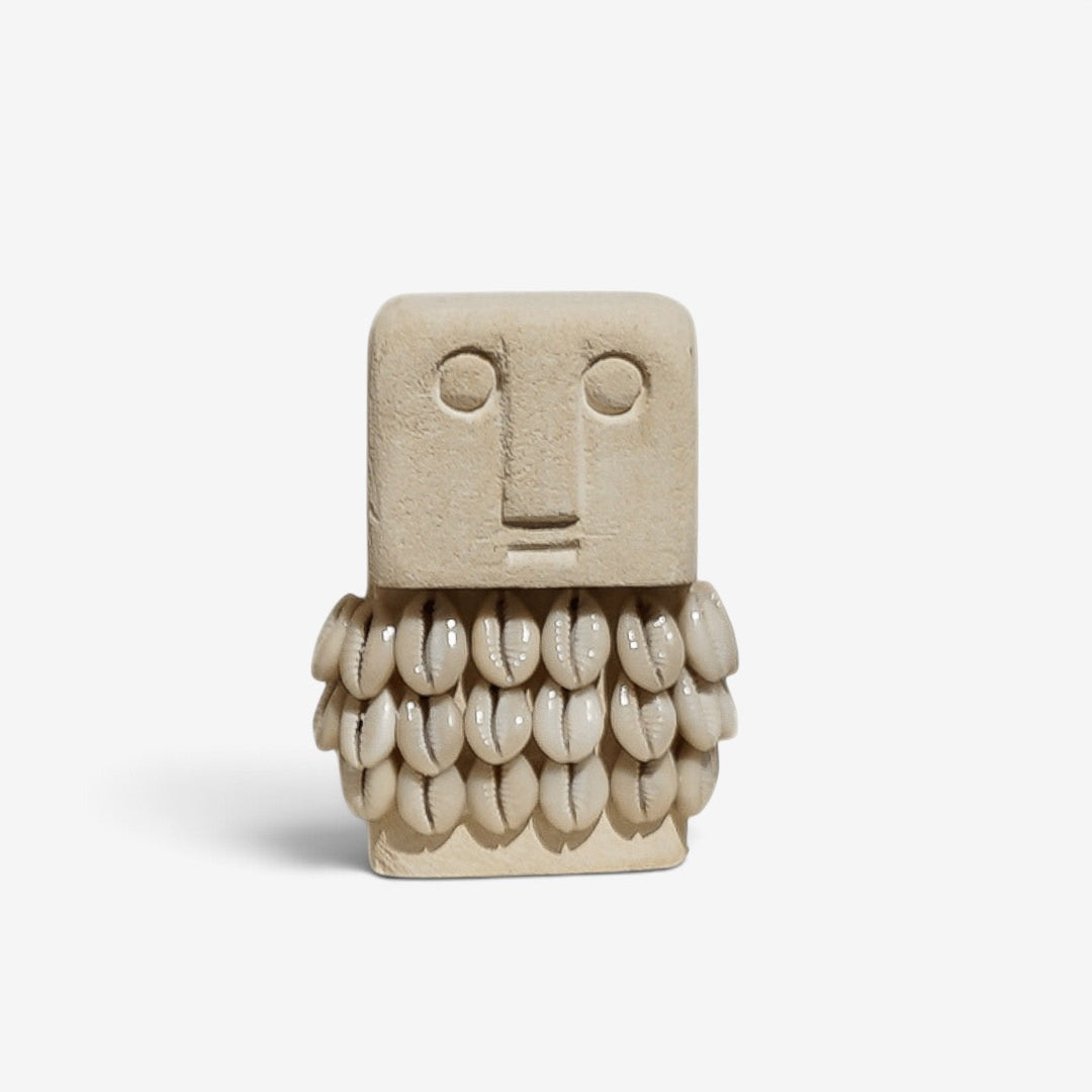 Kayu Living handmade stone figurine featuring a square face and a beard made of natural cowrie shells.