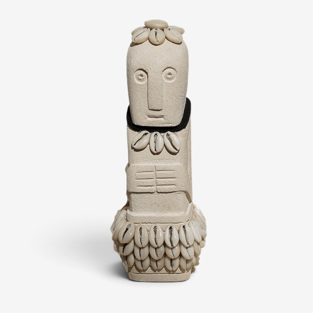 Kayu Living handmade natural stone figurine featuring a carved Boho Stone Man decorated with white cowrie shells.