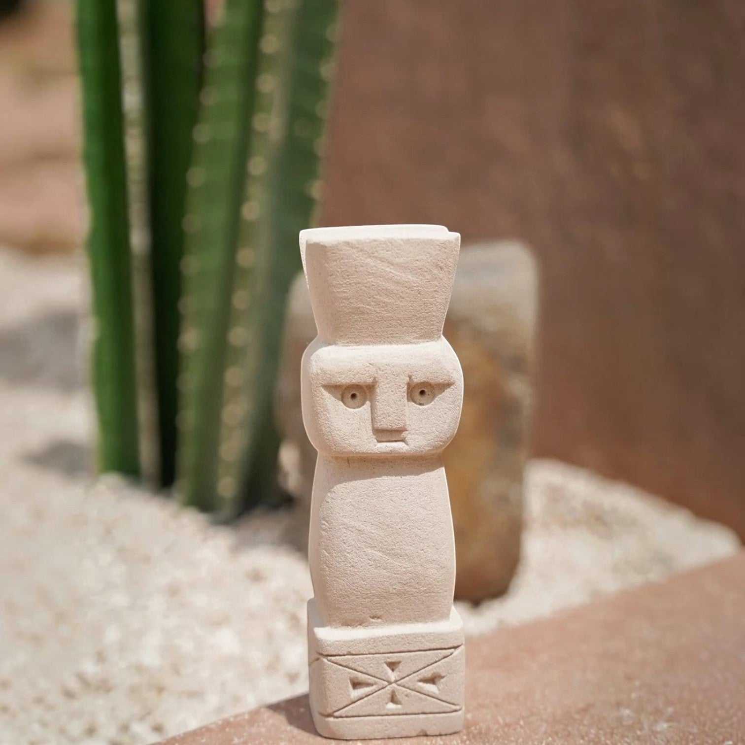 Kayu Living handmade Balinese stone guardian figurine with natural finish and carved geometric base details.