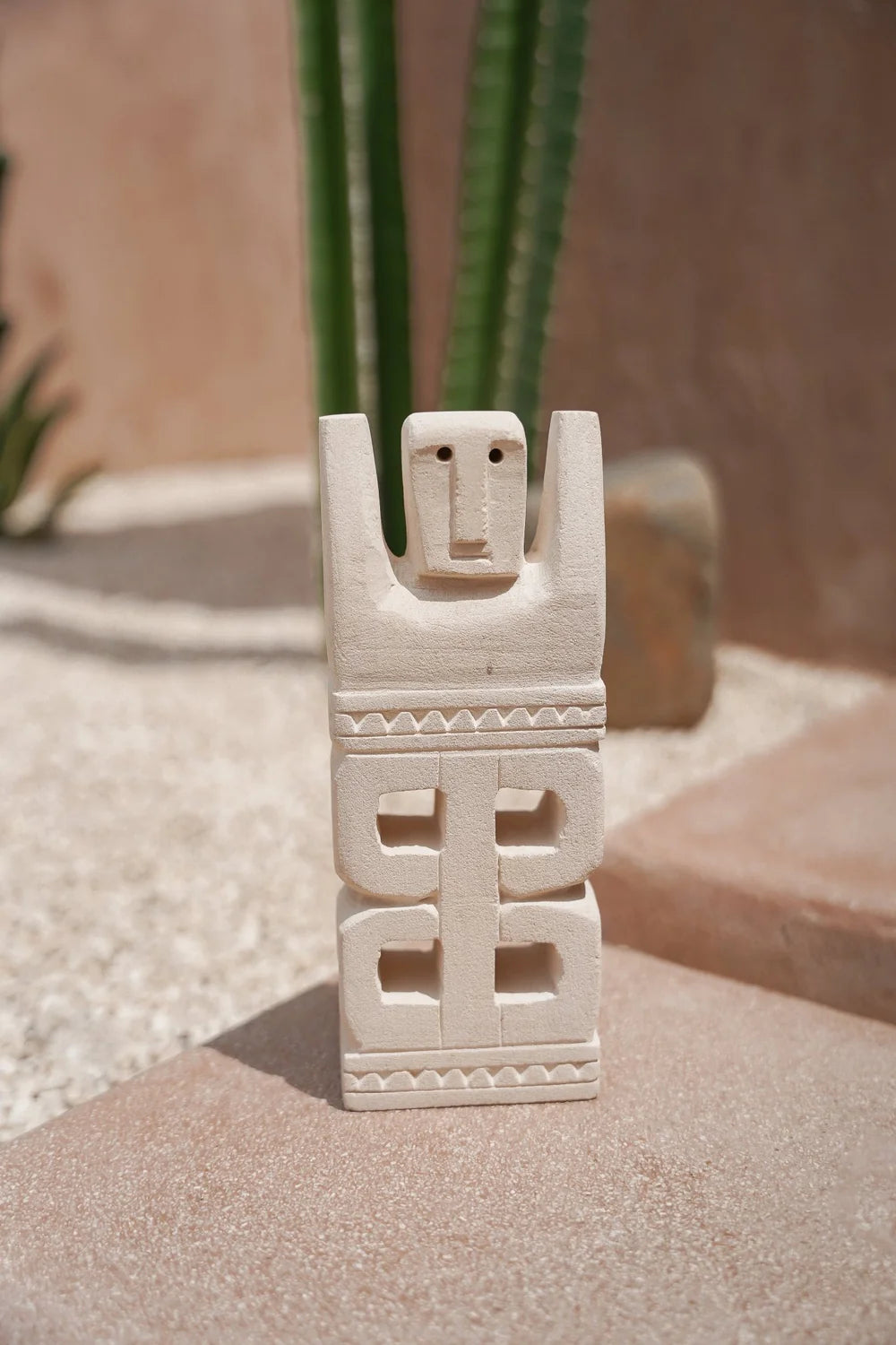Kayu Living hand-carved stone figurine with geometric patterns, a unique Balinese guardian statue for home decor.