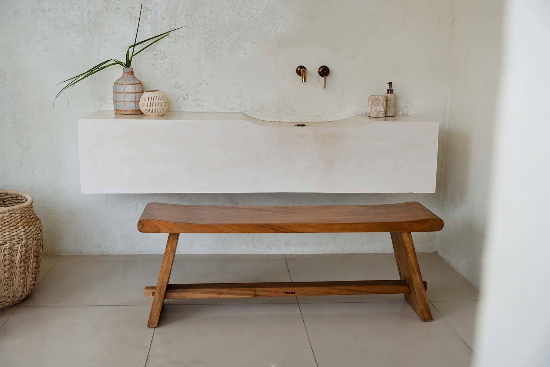 Kayu Living 120 cm handmade solid Suar wood bench with natural grain in a minimalist bathroom setting.