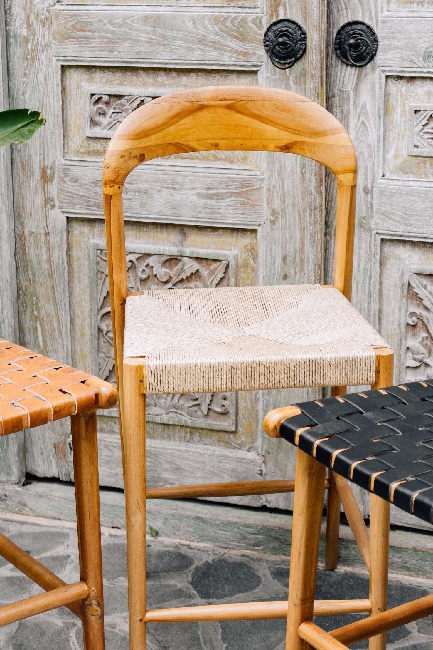 Kayu Living Cemagi teak and natural rope counter stool with curved backrest, suitable for indoor/outdoor use.