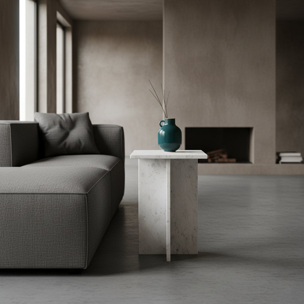 Kayu Living white marble Beijing side table with crossed slab design, featuring grey veining next to a grey sofa.