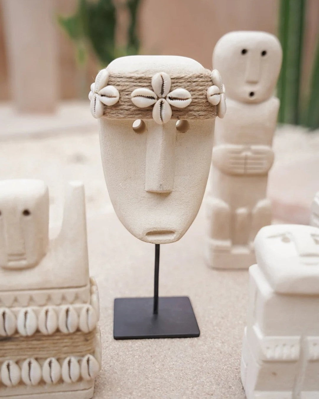 Kayu Living handcrafted white stone mask figurine with seashell headband on a black metal stand for bohemian decor.