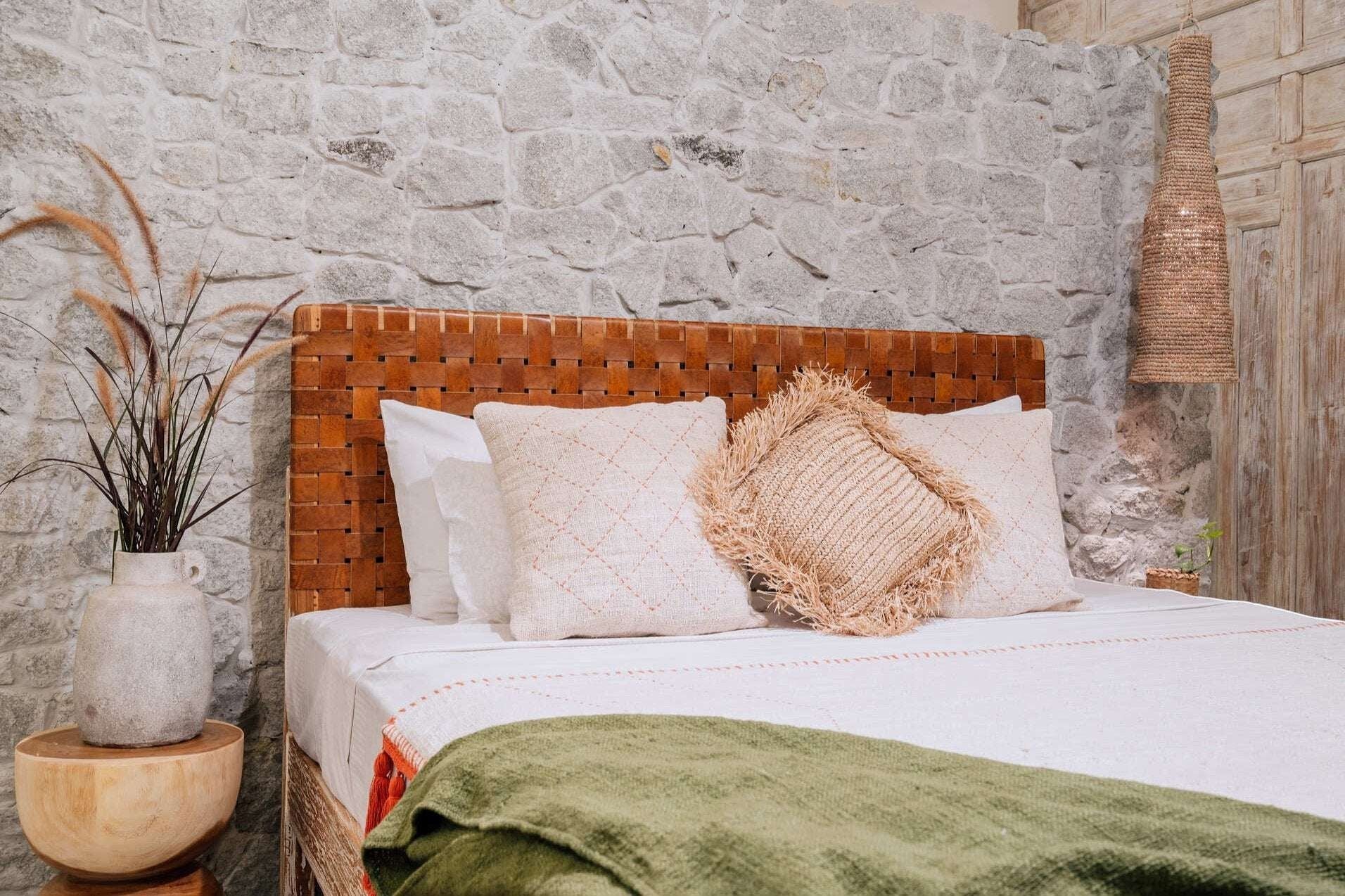 Kayu Living Sanur woven leather headboard with basketweave design in warm brown tones.